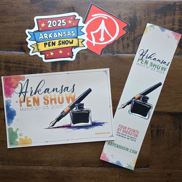 Two stickers, one shaped like the state of Arkansas with a sketch of a pen nib, one in the shape of Arkansas with banners over top that say 2025 Arkansas Pen Show, and a postcard and a bookmark with a similar design including the text Arkansas Pen Show and a graphic of a fountain pen and ink bottle.